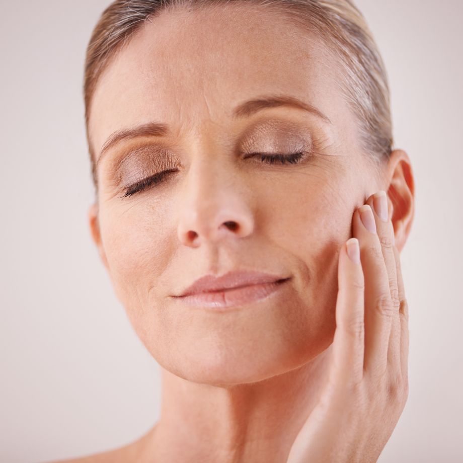 mature woman touching her cheek