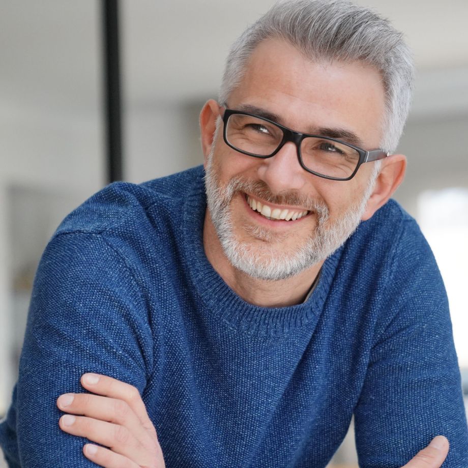 Mature man wearing glasses and a blue sweater